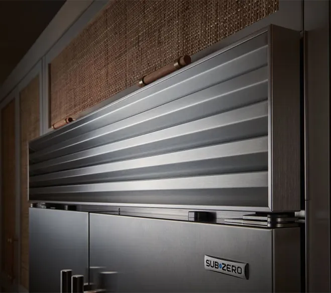 Sub-Zero refrigerator with a raised metal shutter-style cover